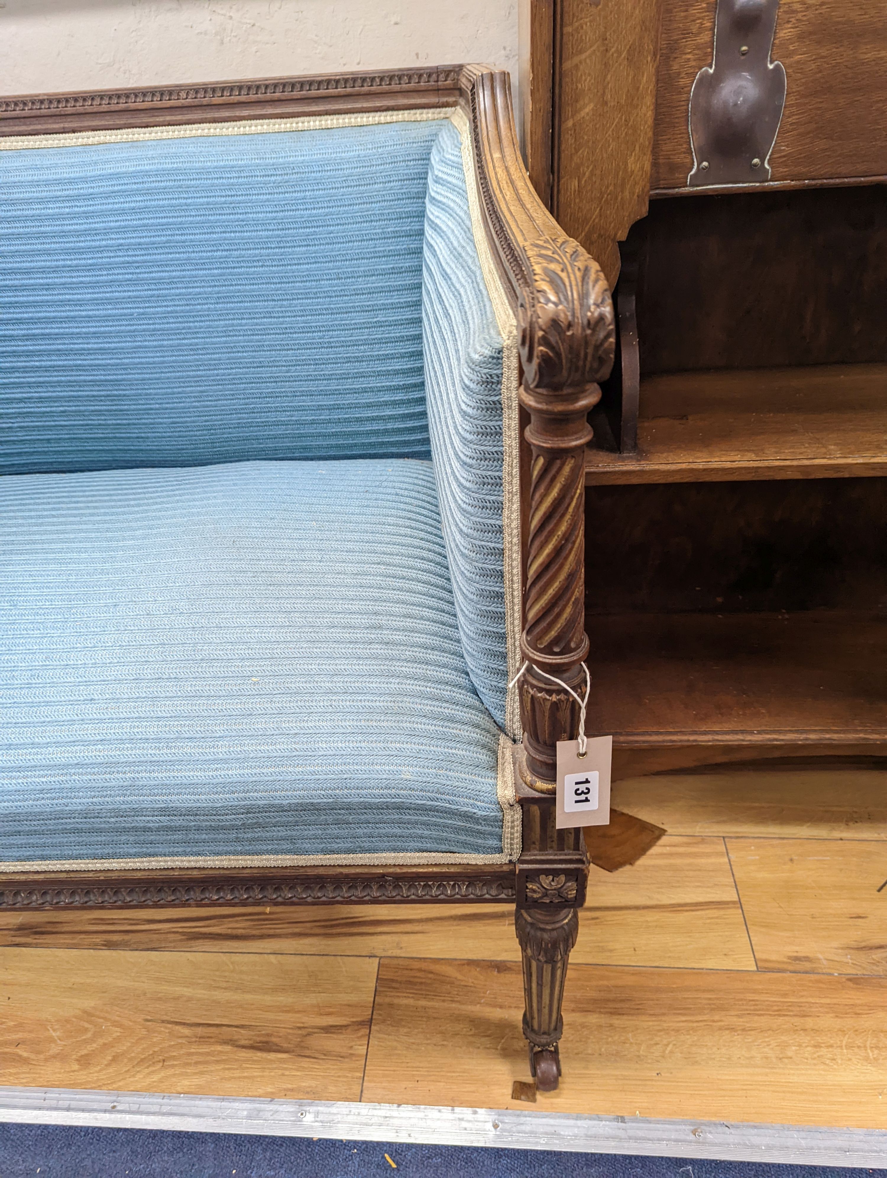 A pair of French walnut and parcel gilt Bergere chairs, width 71cm, depth 59cm, height 72cm